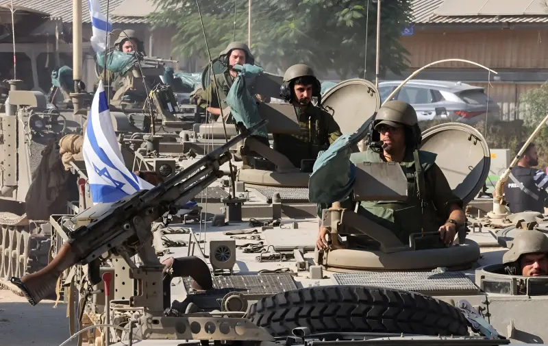 Israeli soldiers on armored vehicles with the Israeli flag and drone control equipment