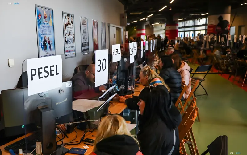 Refugees from Ukraine fill out documents to obtain PESEL with UKR status in a Polish office