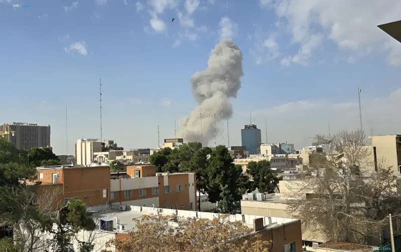 Thick smoke rises over a city following a missile strike, illustrating Iran's retaliatory attack on US bases in Kuwait and Bahrain
