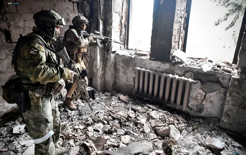 Russian soldiers with Z marking in a destroyed building in Ukraine, illustrating the context of Moscow's provocations