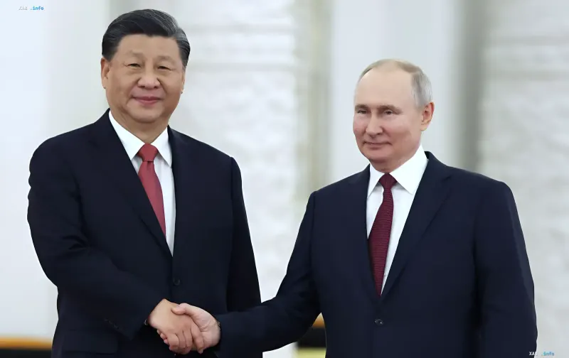 Xi Jinping and Vladimir Putin shaking hands in preparation for Maritime Interaction-2026 exercises in the Yellow Sea