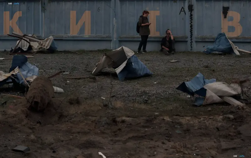 Destroyed shelters and debris against containers after a missile strike, illustrating the threat of a repeat attack in Ukraine