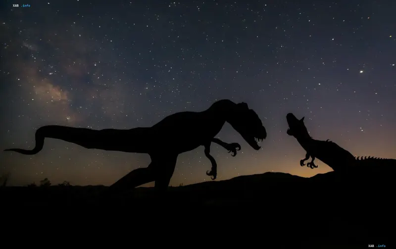 Silhouettes of dinosaurs against a starry sky — illustration for article on new theory of dinosaur extinction: not sulfur, but soot