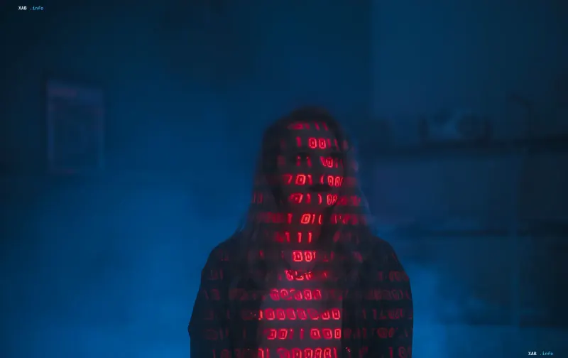 Silhouette of a person with red digital code on the background, symbolizing cyber espionage and data leaks through Zimbra vulnerability