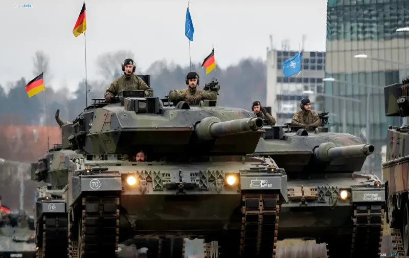 German Leopard 2A7 tanks with German and NATO flags on maneuvers, illustrating the reduction of ammunition purchases by Rheinmetall in 2027