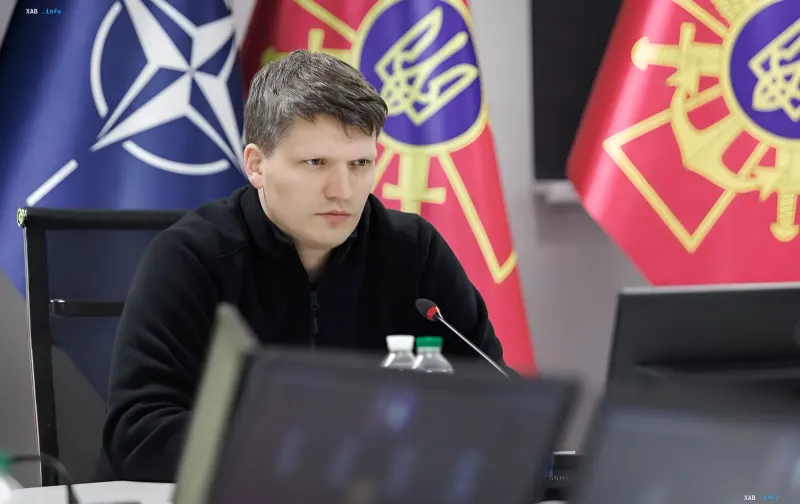 New Deputy Minister of Defense of Ukraine at a negotiation table with NATO and Ukraine flags in the background