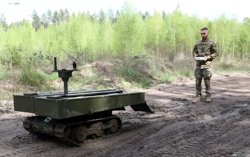Ukrainian soldier operates a combat robot-sapper on the front line in a forested area