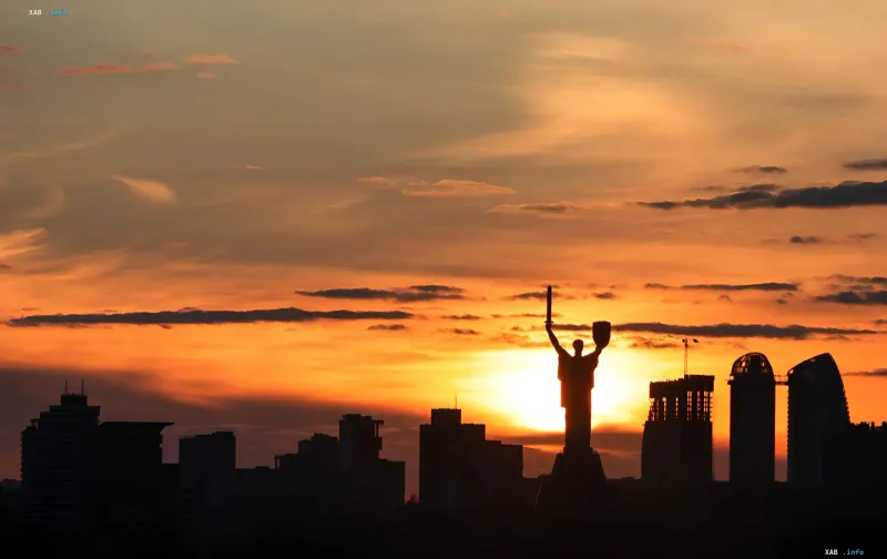 Silhouette of the Motherland Monument in Kyiv against a golden sunset, symbolizing the beauty of Ukraine’s 'golden hour'