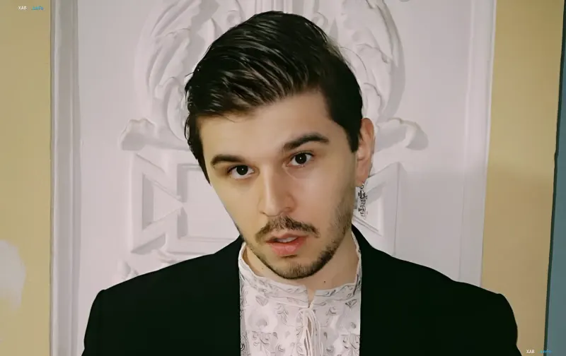 M1SHKA as the music producer of the revamped 'Fabrika Zvyozd' on SWEET.TV — portrait with a serious gaze and stylish outfit
