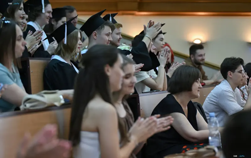 Graduates in gowns and caps applaud at a diploma ceremony in Lviv, illustrating the rising cost of university education for 2026 applicants