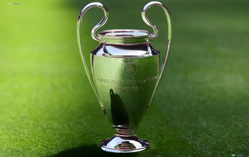 UEFA Champions League trophy on a green pitch, symbolizing the start of the qualifying stage and the schedule for the third round
