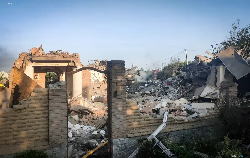 Destroyed home in Sumy or Mykolaiv after strike: rubble of walls, bricks and roof, smoke against clear sky — aftermath of attack that killed children and elderly