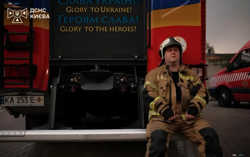 Ukrainian firefighter rests near fire truck with 'Glory to Ukraine!' slogan after night attack that killed 17 people