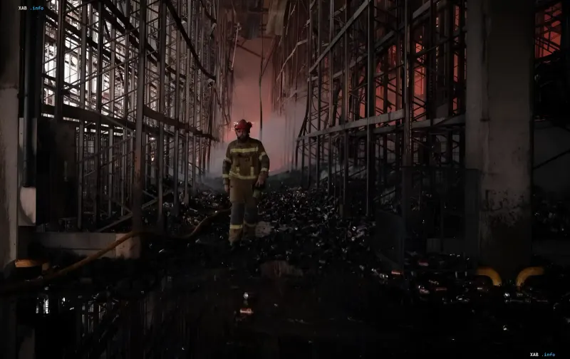 Firefighter surveying fire damage inside a destroyed building after missile strike on Kyiv region