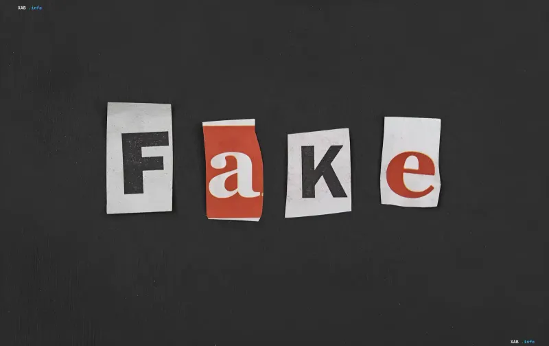 Слово 'FAKE' з вирізаних літер на чорному фоні, що символізує фейкові новини та ІІ-маніпуляції з фотографіями загиблих українців