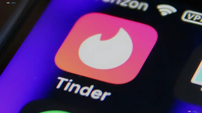 Tinder app logo on a smartphone screen, symbolizing the shift from online dating to offline events