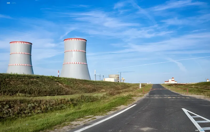 Massive cooling towers of a nuclear power plant in Romania against a clear sky, symbolizing the struggle for energy stability