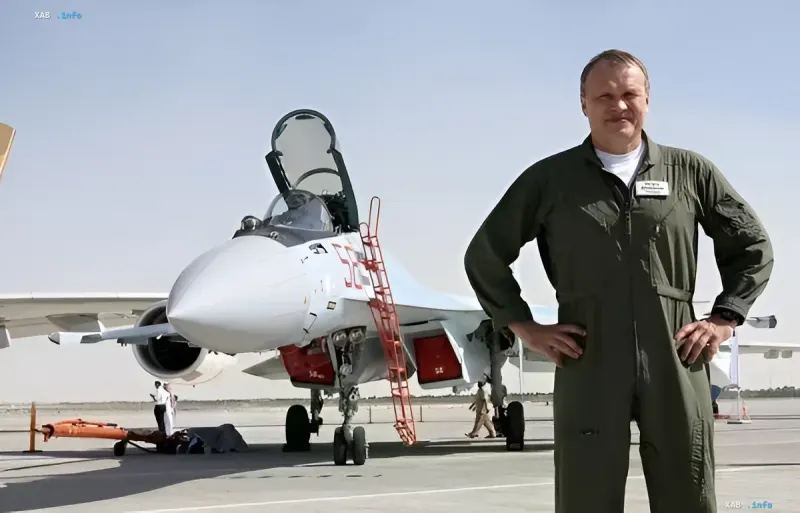 Chief test pilot of Sukhoi in a flight suit standing next to a Su-57 fighter jet on the airfield