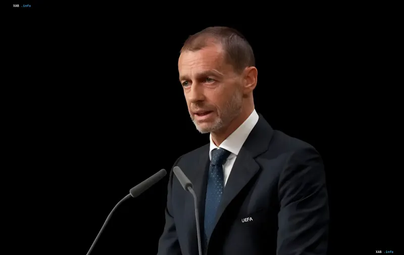 UEFA President Aleksander Ceferin in a dark suit at a microphone with the UEFA logo on his lapel, having declined the FIFA presidency
