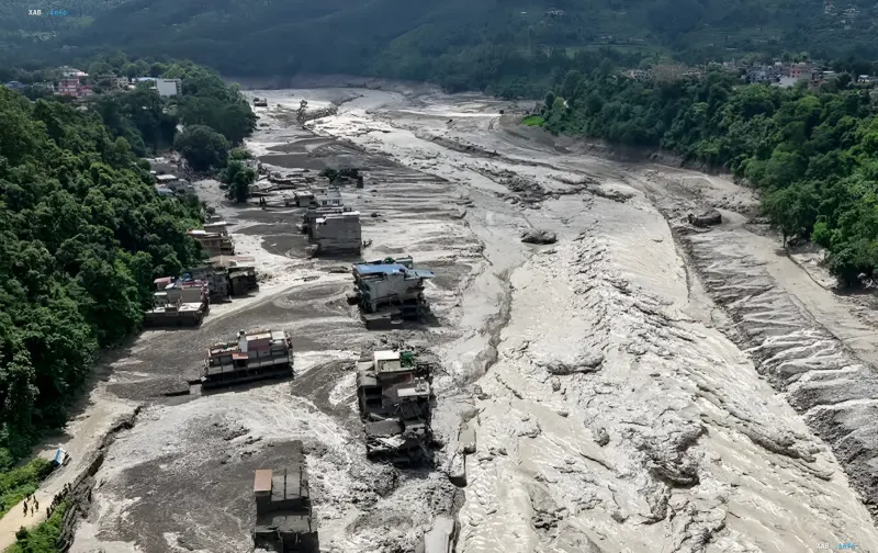 Aftermath of the Nepal flood: destroyed houses and a river clogged with mud and debris