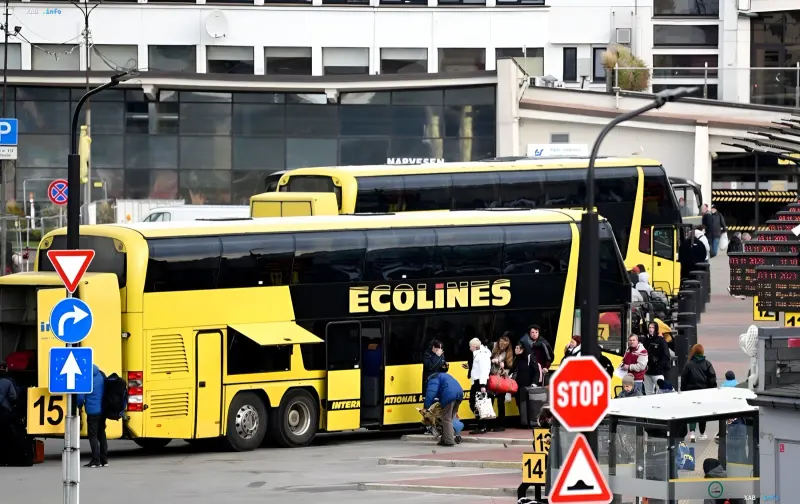 Ecolines double-decker buses with passengers at a Latvian bus station ahead of the planned ban on routes to Russia and Belarus