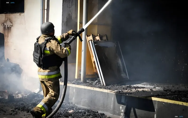 Firefighter extinguishes a fire in a building after a drone attack in Dnipro
