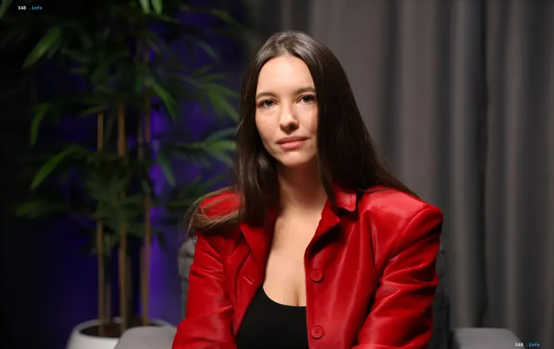 Stylist Olga Galushka in a red jacket during an interview about wardrobe basics and Ukrainian brand pricing
