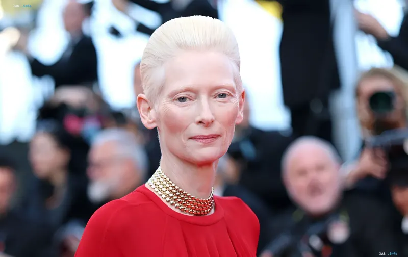 Tilda Swinton in a red dress and Cartier necklace at the announcement of her ambassadorship with the jeweler