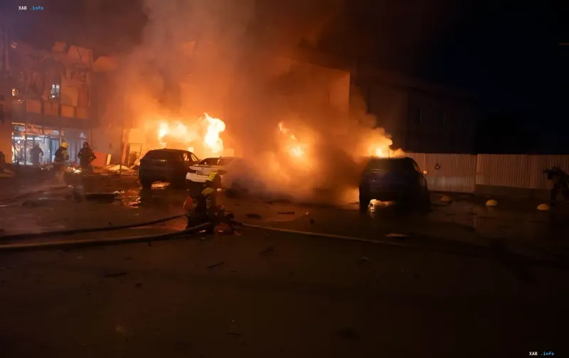 Fire after a drone strike on Manufaktura shopping mall in Sumy: burning cars and firefighters battling the flames at night
