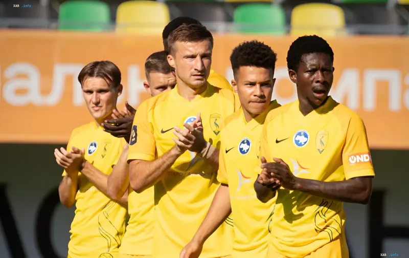 FC Polesie players in yellow kits applauding at the stadium ahead of the UPL match relocated from Kyiv to Zhytomyr
