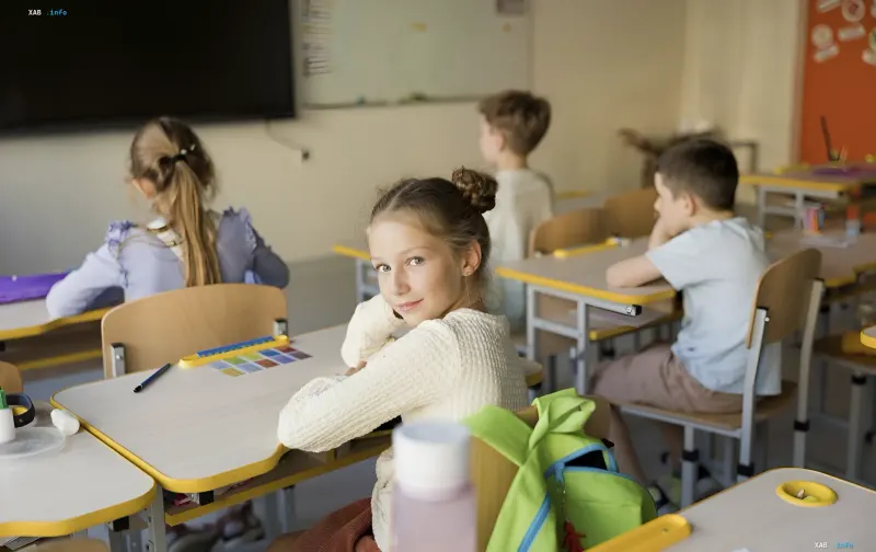 Students at desks in a school classroom: lessons under the yellow safety level