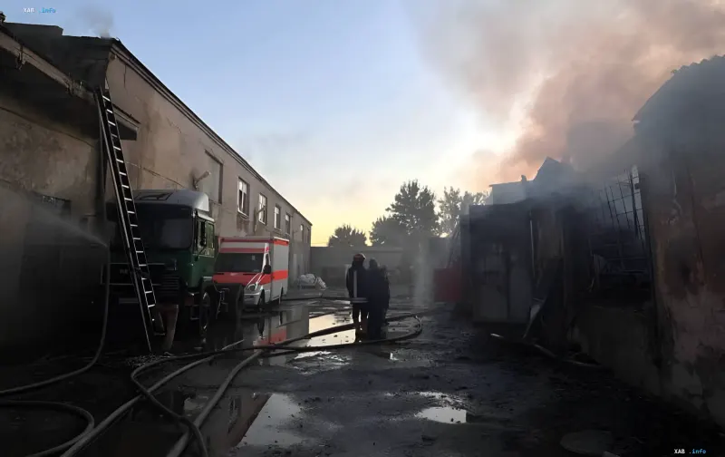 Aftermath of enemy attack in Odesa: destroyed volunteer organization warehouses with humanitarian aid, smoke, firefighters and ambulance at the scene
