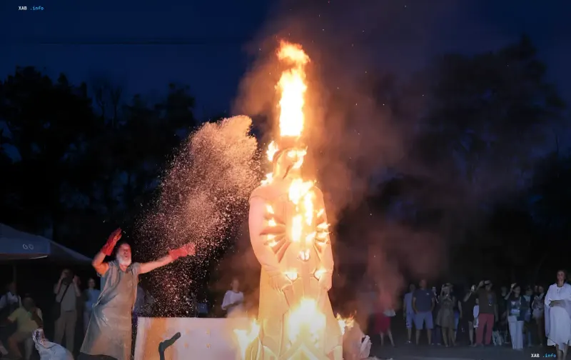 Fire dedication of the 'Kozak-Kharakternyk' sculpture on Khortytsia: a burning 2.5-meter Cossack figure with a column of flame and onlookers