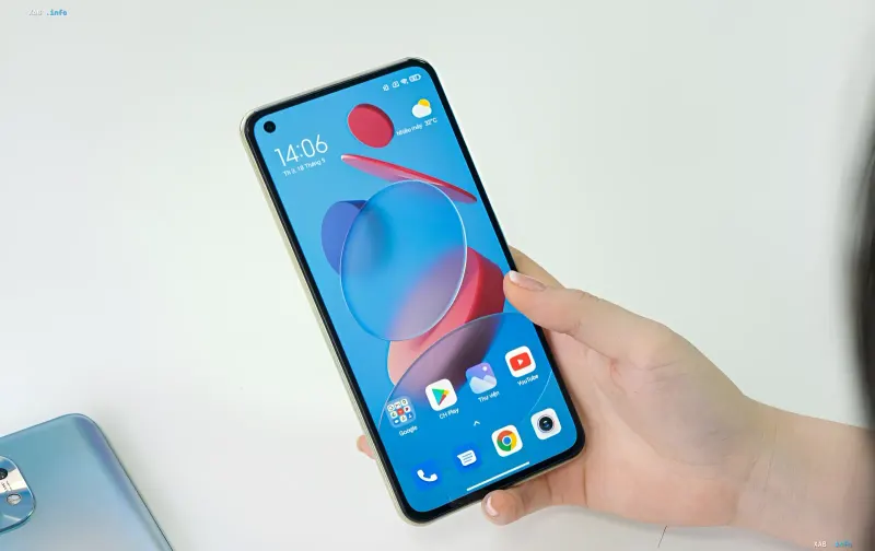 Xiaomi smartphone with HyperOS 4 interface in a user's hand during global beta testing of the Android 17-based firmware