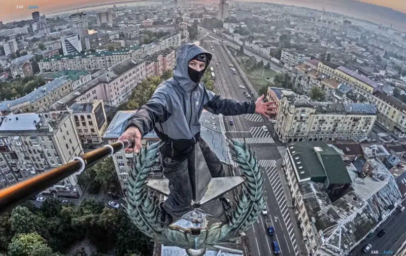 Руфер із селфі-палицею на вершині зірки харківського «Дома зі шпилем» на тлі світанку