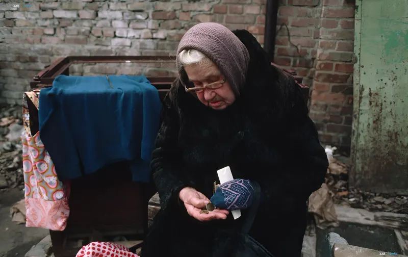 Elderly person counting coins on a table