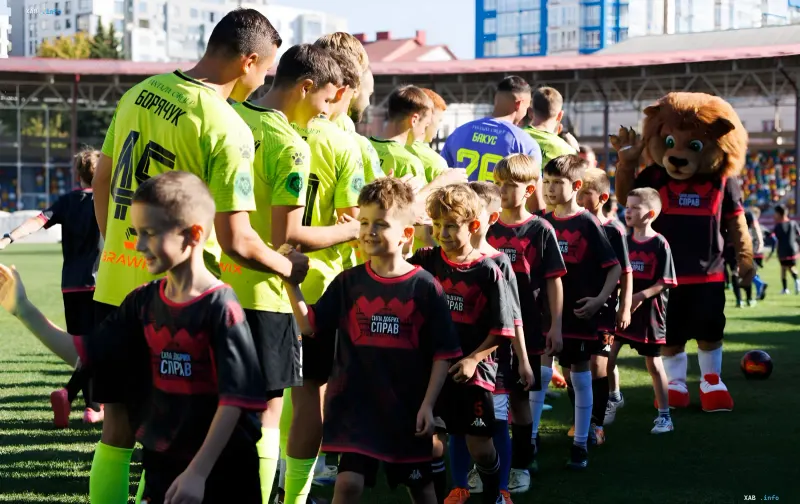 Children playing football with FC Nyva players