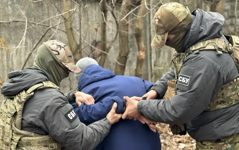 Ukrainian law enforcement officers detain a suspect in camouflage gear with SBU patches in Kharkiv