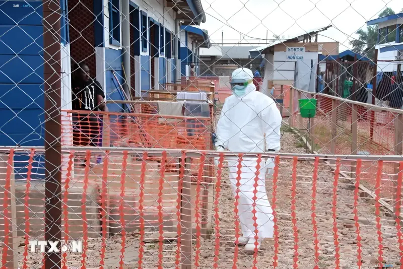 Medical workers in protective gear combat the Ebola outbreak in the DRC