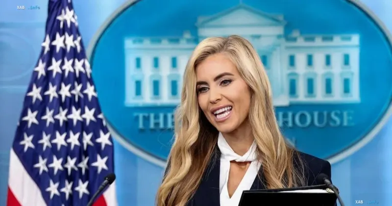 White House Press Secretary Kattie Zacharia speaking at a briefing against the American flag background