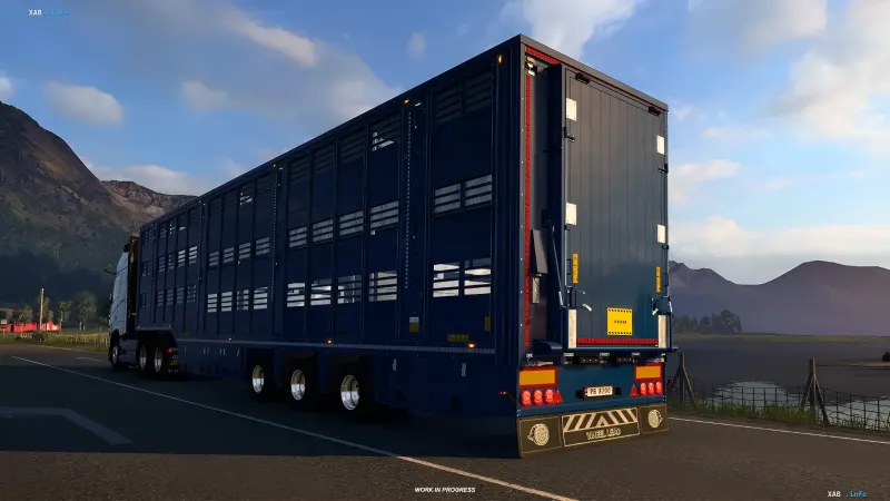Blue livestock trailer attached to a truck on a road in Euro Truck Simulator 2
