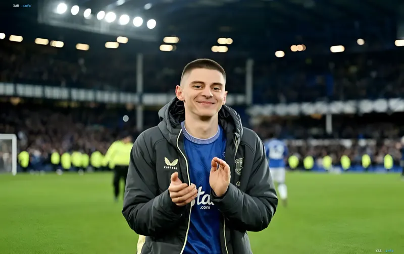 Everton footballer Vitaliy Mykolenko smiles and applauds the stands after the match against Chelsea