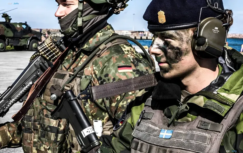 Military personnel in camouflage with weapons during exercises