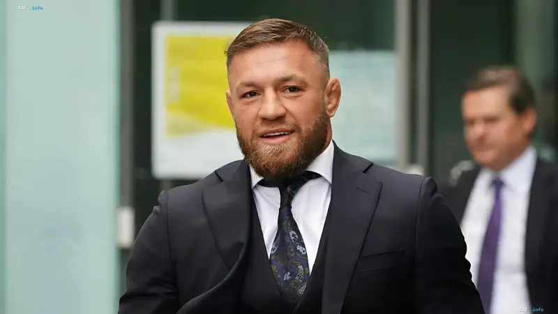 Conor McGregor in a dark suit and tie before returning to the UFC