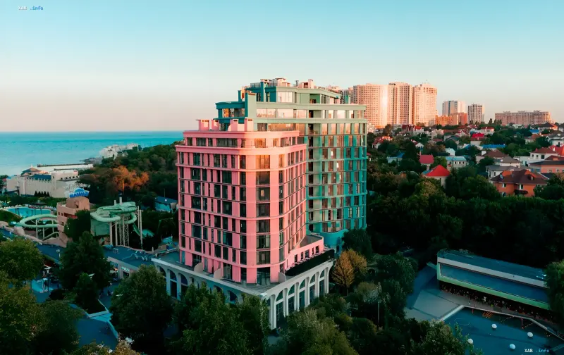 Bright pink and green residential buildings by PROSTRANSTVO developer in Odesa against the sea
