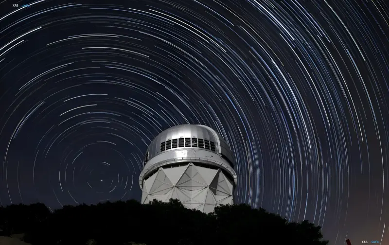 Observatory with star trails in the night sky