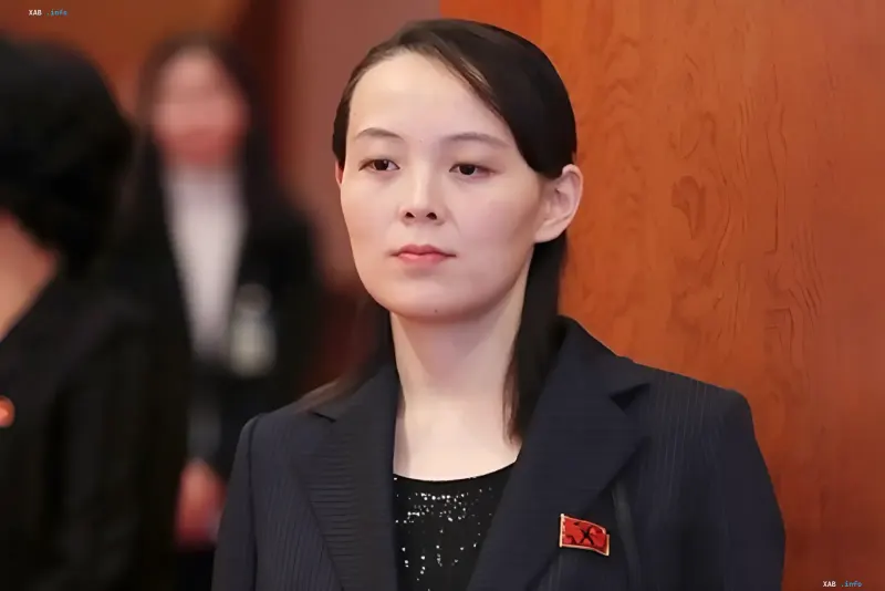 Kim Yo Jong giving an official statement against a wooden panel background