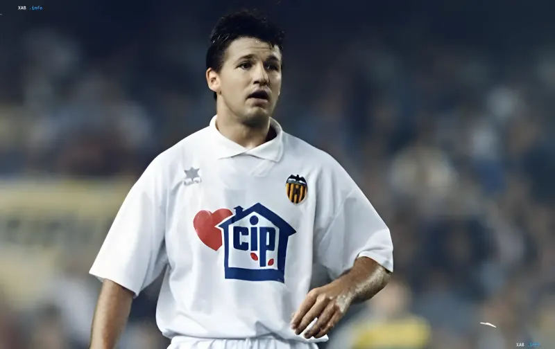 Oleg Salenko wearing a white Valencia shirt during a football match on the pitch