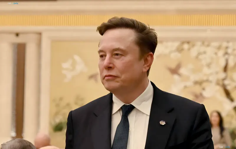 Elon Musk in a formal suit at an official event