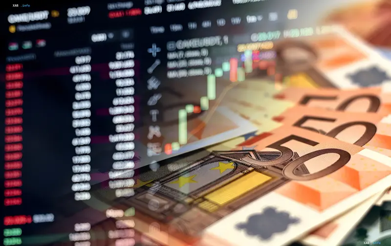 Trading charts on a monitor and stacks of euro banknotes against an economic background